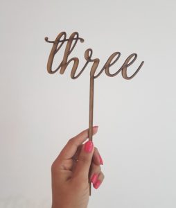"three" laser-cut topper
