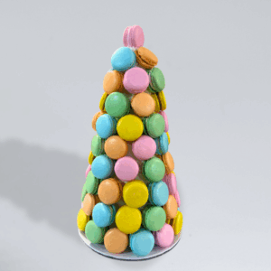 Pastel macaron tower featuring yellow, pink, green and blue macarons