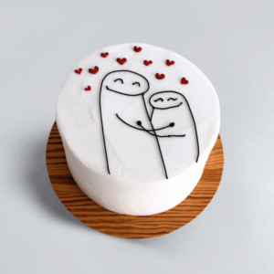 15cm Sweethearts Meme cake with smooth white frosting, featuring minimalist cartoon-style couple figures embracing and surrounded by small red heart decorations.