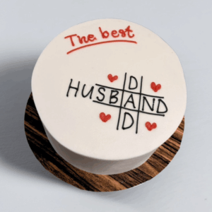 Tic Tac Love Cake with white icing, crossword design, red hearts, and 
