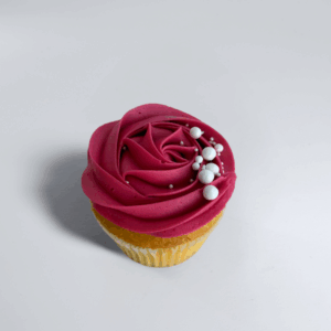 Roses & pearls cupcake frosted cupcake with white pearl sprinkles on a golden sponge base