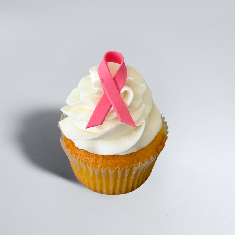 vanilla cupcake, with plain white buttercream and a pink ribbon
