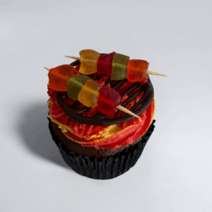 Sweet & Sizzle chocolate cupcake topped with red and yellow buttercream, chocolate grill piping and colourful gummy skewers.